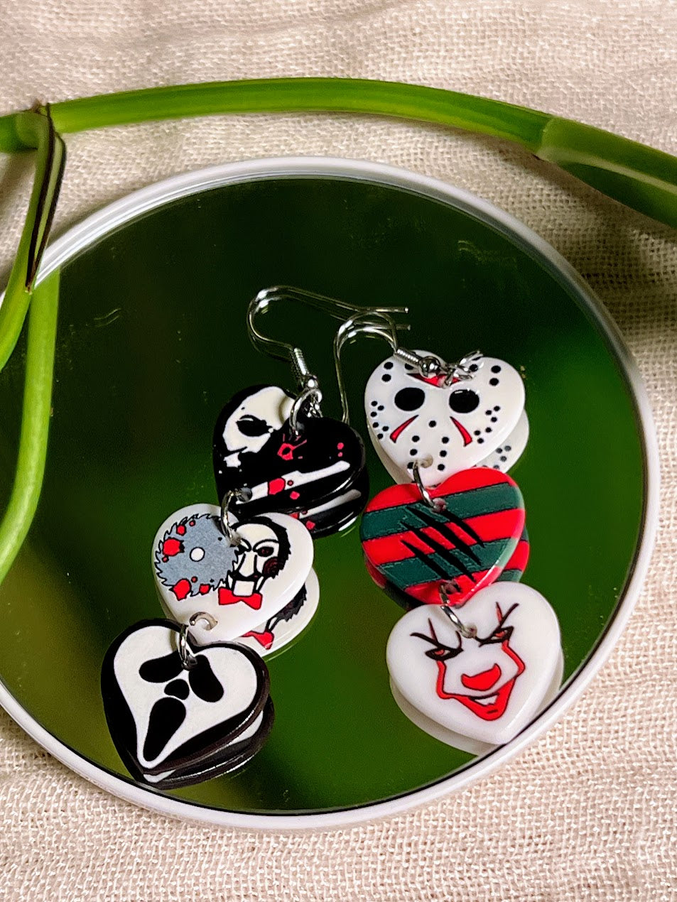 Close-up of Acrylic Horror Heart Earrings featuring slasher characters
